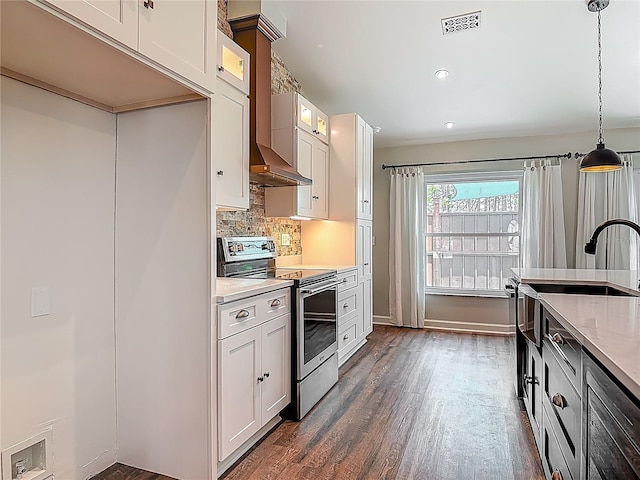 14 Zollinger Pl, Palm Coast, FL 32164 - kitchen with stainless steel electric range oven, dark wood finished floors, glass insert cabinets, tasteful backsplash, and pendant lighting