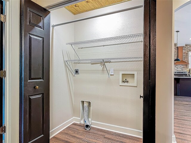 14 Zollinger Pl, Palm Coast, FL 32164 - laundry room with electric dryer hookup, wood finished floors, arched walkways, baseboards, and washer hookup