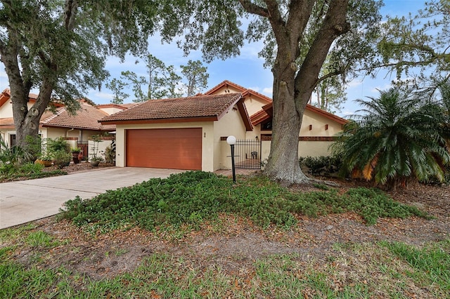 55 Village Cir, Palm Coast, FL 32164 - mediterranean / spanish-style home with a tiled roof, stucco siding, an attached garage, and driveway