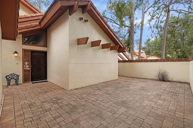 55 Village Cir, Palm Coast, FL 32164 - property entrance featuring stucco siding and a patio