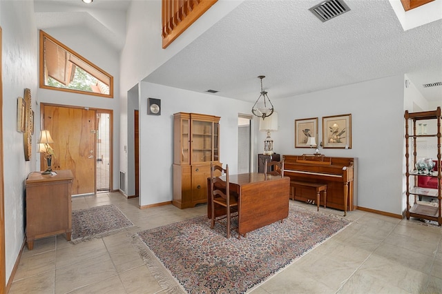 55 Village Cir, Palm Coast, FL 32164 - entryway with baseboards, a textured ceiling, light tile patterned floors, and a towering ceiling