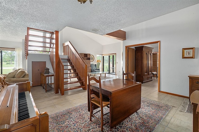 55 Village Cir, Palm Coast, FL 32164 - dining space featuring a textured ceiling, stairs, baseboards, and lofted ceiling