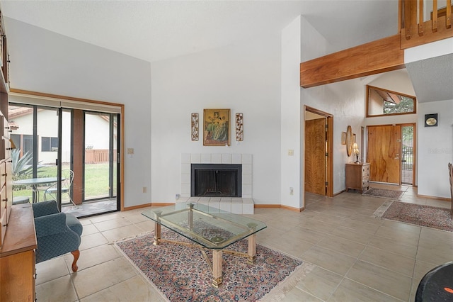 55 Village Cir, Palm Coast, FL 32164 - living area featuring light tile patterned flooring, a tile fireplace, baseboards, and high vaulted ceiling