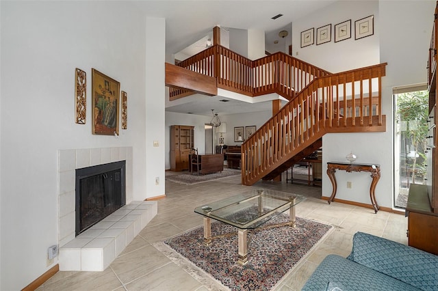 55 Village Cir, Palm Coast, FL 32164 - unfurnished living room with stairs, a fireplace, a high ceiling, and baseboards