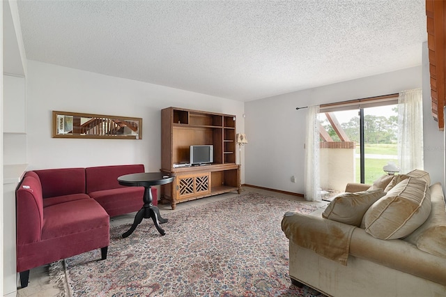 55 Village Cir, Palm Coast, FL 32164 - living area featuring a textured ceiling and baseboards