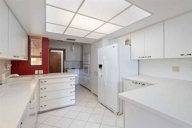 55 Village Cir, Palm Coast, FL 32164 - kitchen featuring a sink, white appliances, light tile patterned flooring, and light countertops
