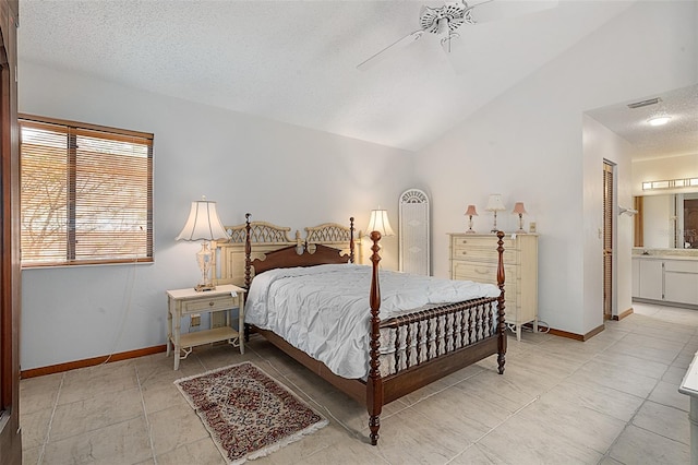 55 Village Cir, Palm Coast, FL 32164 - bedroom with a textured ceiling, light tile patterned floors, vaulted ceiling, ensuite bath, and baseboards