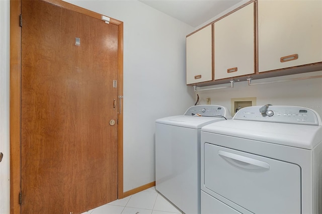 55 Village Cir, Palm Coast, FL 32164 - washroom with cabinet space, independent washer and dryer, light tile patterned floors, and baseboards