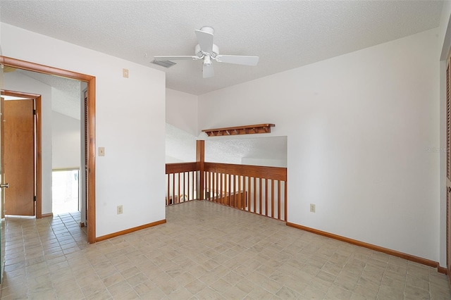 55 Village Cir, Palm Coast, FL 32164 - unfurnished room featuring a ceiling fan, baseboards, and a textured ceiling