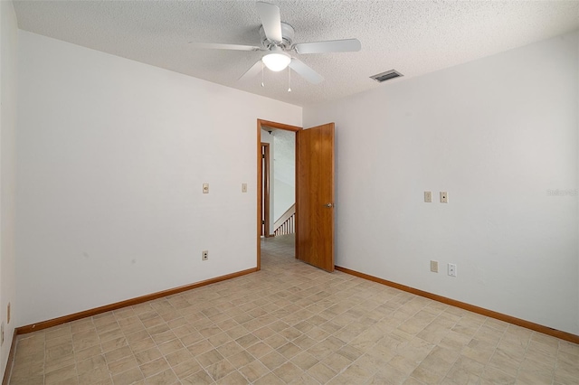 55 Village Cir, Palm Coast, FL 32164 - empty room featuring a ceiling fan, a textured ceiling, and baseboards