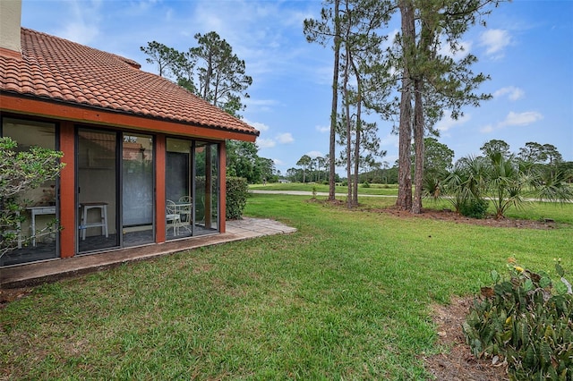 55 Village Cir, Palm Coast, FL 32164 - view of grassy yard with a sunroom