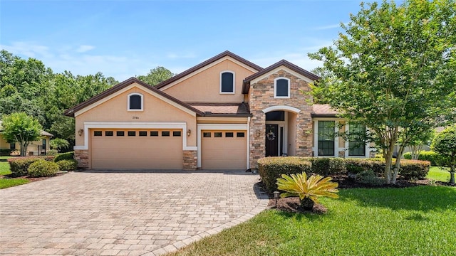 2064 Crown Dr, Saint Augustine, FL 32092 - traditional-style house with stucco siding, stone siding, decorative driveway, and a garage