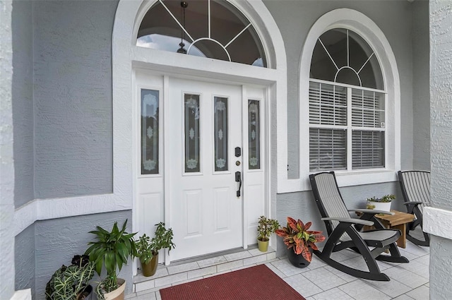 80 Flemingwood Ln, Palm Coast, FL 32137 - property entrance featuring stucco siding and covered porch