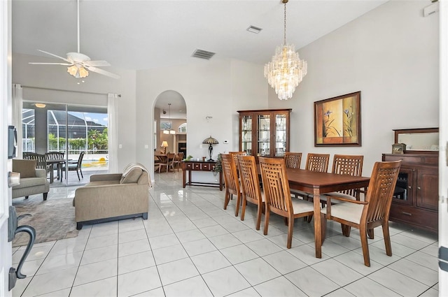 80 Flemingwood Ln, Palm Coast, FL 32137 - dining space with arched walkways, ceiling fan, light tile patterned flooring, a chandelier, and a towering ceiling