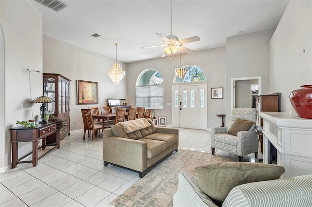 80 Flemingwood Ln, Palm Coast, FL 32137 - living area featuring light tile patterned floors, a chandelier, a ceiling fan, a towering ceiling, and baseboards