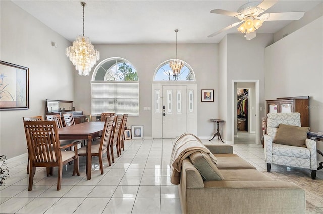 80 Flemingwood Ln, Palm Coast, FL 32137 - dining room featuring a chandelier, light tile patterned floors, a ceiling fan, a high ceiling, and baseboards