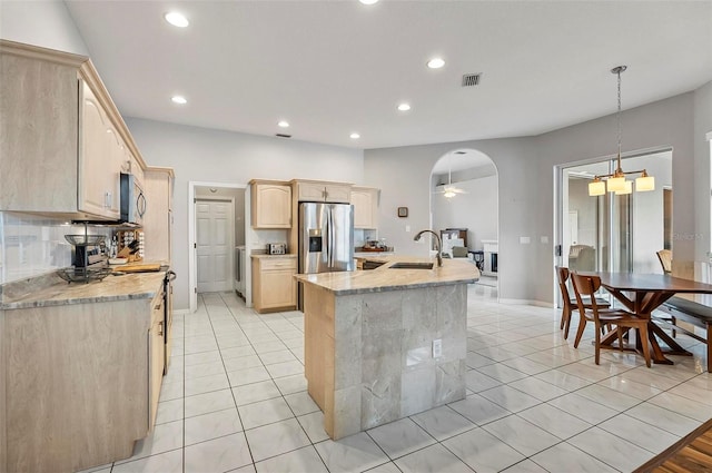 80 Flemingwood Ln, Palm Coast, FL 32137 - kitchen with appliances with stainless steel finishes, light brown cabinetry, a kitchen island with sink, recessed lighting, and light tile patterned floors