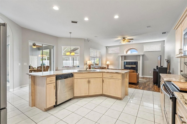 80 Flemingwood Ln, Palm Coast, FL 32137 - kitchen with stainless steel dishwasher, ceiling fan, light brown cabinetry, electric range, and a sink