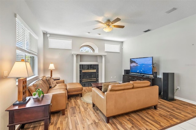 80 Flemingwood Ln, Palm Coast, FL 32137 - living area featuring ceiling fan, light wood finished floors, a tile fireplace, and plenty of natural light