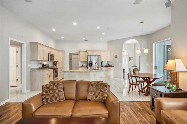 80 Flemingwood Ln, Palm Coast, FL 32137 - living room featuring arched walkways, recessed lighting, baseboards, and light tile patterned floors