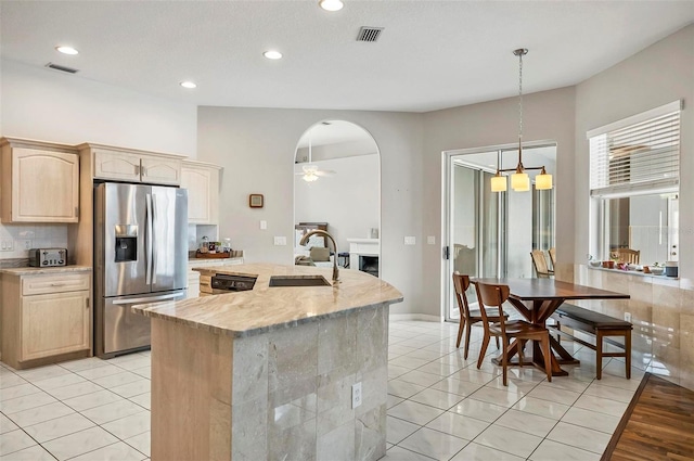 80 Flemingwood Ln, Palm Coast, FL 32137 - kitchen featuring stainless steel appliances, a sink, light brown cabinetry, a center island with sink, and ceiling fan
