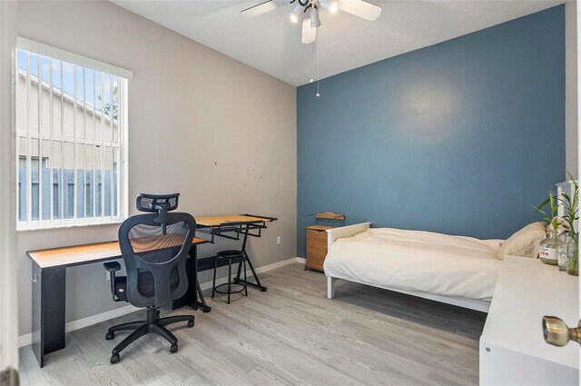 80 Flemingwood Ln, Palm Coast, FL 32137 - bedroom with wood finished floors, an office area, baseboards, and a ceiling fan