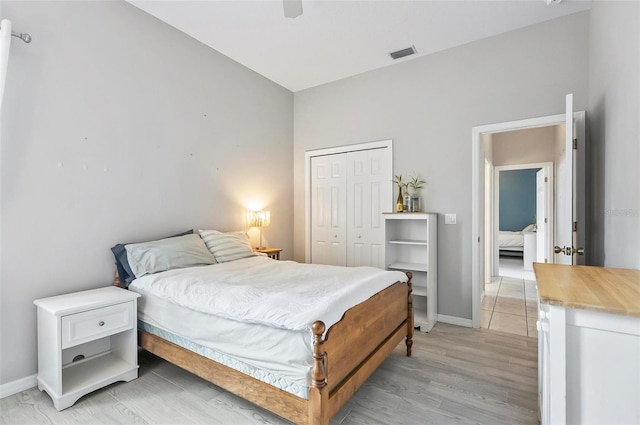80 Flemingwood Ln, Palm Coast, FL 32137 - bedroom featuring a closet, light wood-type flooring, baseboards, and a ceiling fan