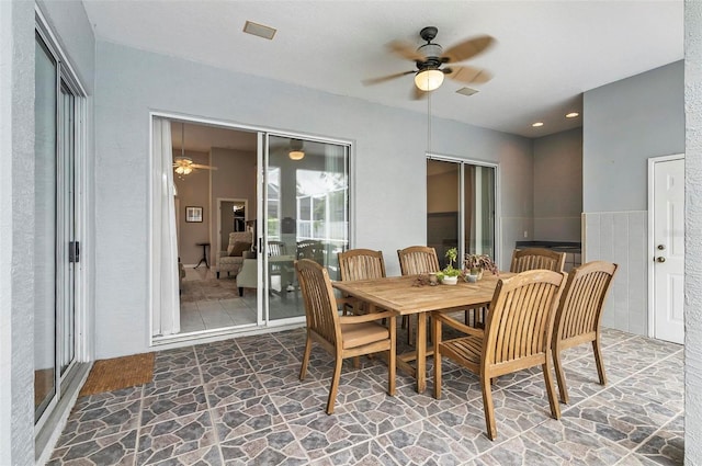 80 Flemingwood Ln, Palm Coast, FL 32137 - dining area featuring ceiling fan and stone finish floors
