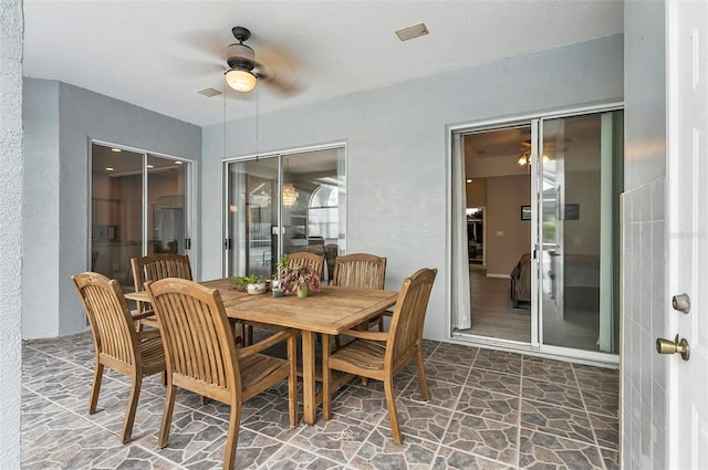 80 Flemingwood Ln, Palm Coast, FL 32137 - dining area with ceiling fan and stone floors