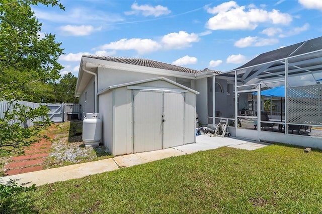 80 Flemingwood Ln, Palm Coast, FL 32137 - rear view of house with glass enclosure, a tile roof, and a patio area