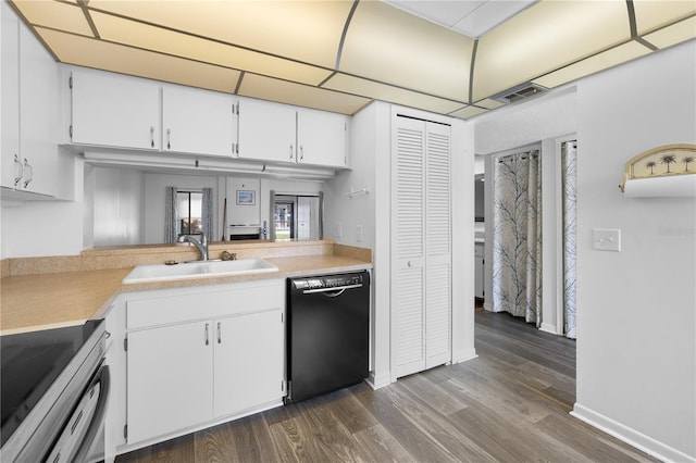 1 Tomoka Oaks Blvd Unit 135, Ormond Beach, FL 32174 - kitchen featuring black dishwasher, a sink, range, white cabinets, and light countertops