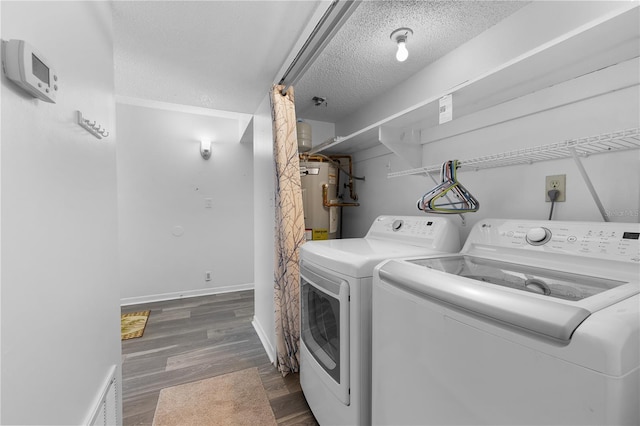 1 Tomoka Oaks Blvd Unit 135, Ormond Beach, FL 32174 - washroom featuring washer and dryer, a textured ceiling, water heater, wood finished floors, and baseboards