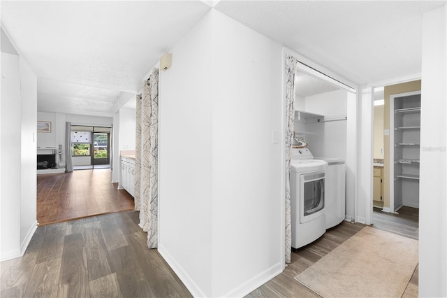 1 Tomoka Oaks Blvd Unit 135, Ormond Beach, FL 32174 - laundry room with washer and dryer, dark wood-type flooring, and baseboards