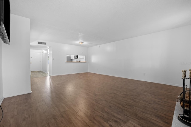 1 Tomoka Oaks Blvd Unit 135, Ormond Beach, FL 32174 - unfurnished living room featuring wood finished floors and baseboards