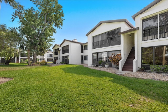 1 Tomoka Oaks Blvd Unit 135, Ormond Beach, FL 32174 - view of green lawn featuring stairway
