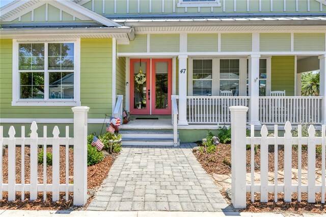 47 Hidden Treasure Dr, Palm Coast, FL 32137 - view of exterior entry featuring covered porch and board and batten siding