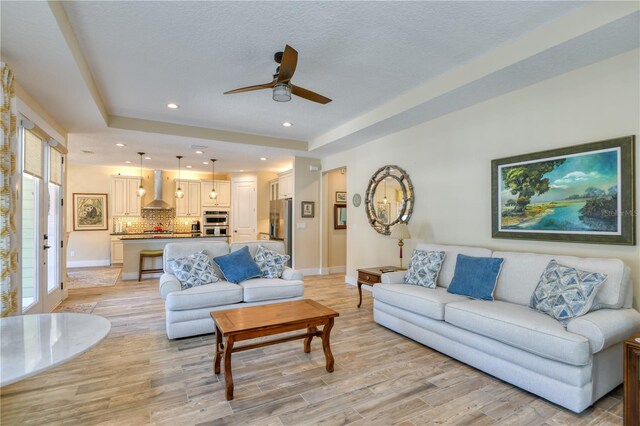 47 Hidden Treasure Dr, Palm Coast, FL 32137 - living room featuring light wood finished floors, ceiling fan, baseboards, and recessed lighting