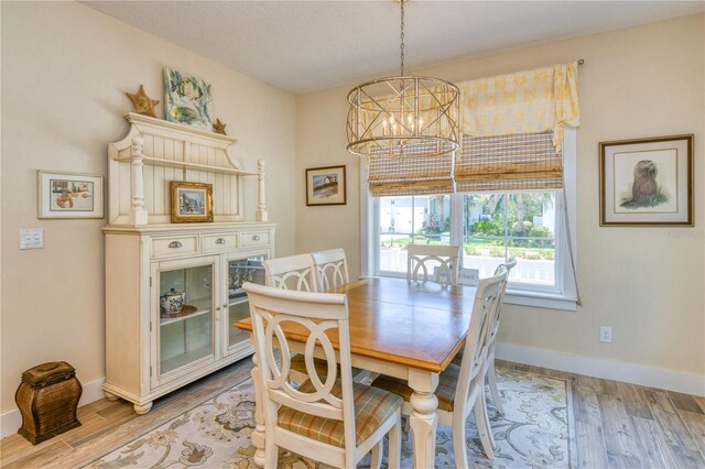 47 Hidden Treasure Dr, Palm Coast, FL 32137 - dining area with a chandelier, baseboards, and wood finished floors