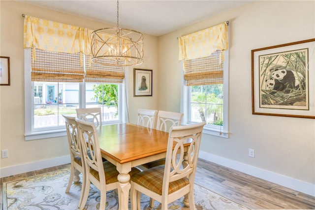 47 Hidden Treasure Dr, Palm Coast, FL 32137 - dining area with a chandelier, baseboards, and wood finished floors