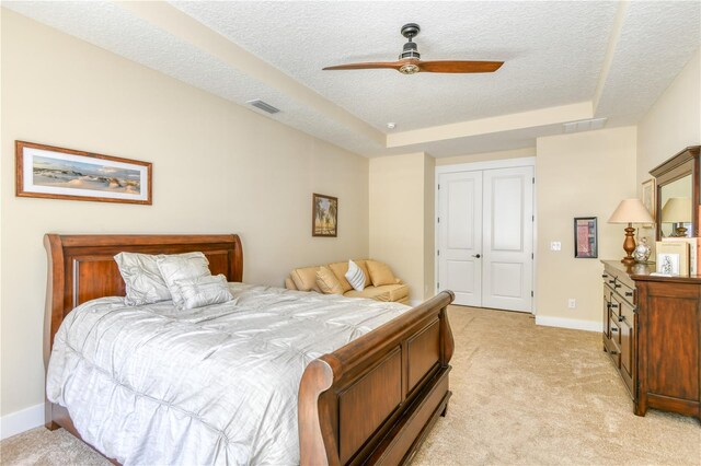 47 Hidden Treasure Dr, Palm Coast, FL 32137 - bedroom featuring a raised ceiling, light carpet, a textured ceiling, a closet, and baseboards