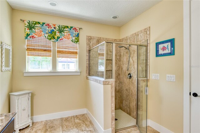 47 Hidden Treasure Dr, Palm Coast, FL 32137 - full bathroom with a stall shower, baseboards, a textured ceiling, and vanity