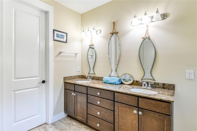 47 Hidden Treasure Dr, Palm Coast, FL 32137 - full bathroom with double vanity and baseboards