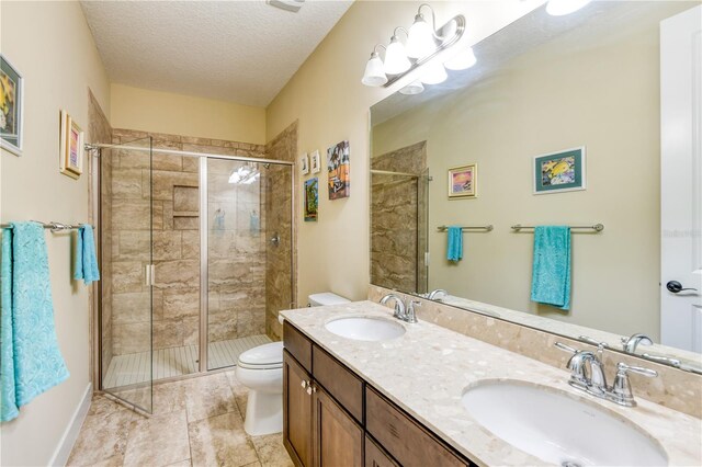 47 Hidden Treasure Dr, Palm Coast, FL 32137 - full bath featuring toilet, a shower stall, double vanity, a textured ceiling, and tile patterned floors