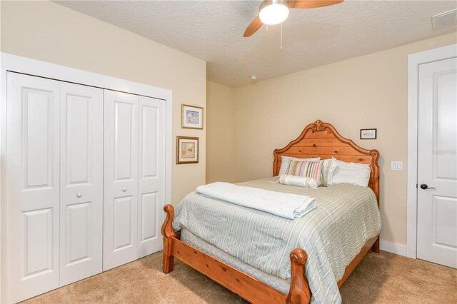 47 Hidden Treasure Dr, Palm Coast, FL 32137 - bedroom with light colored carpet, a closet, ceiling fan, and a textured ceiling