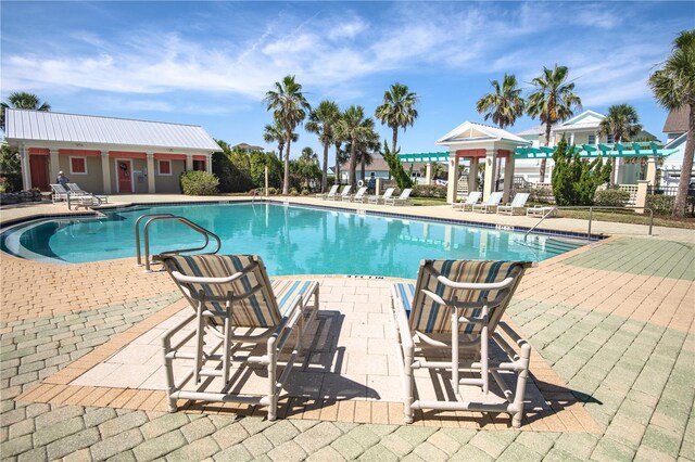 47 Hidden Treasure Dr, Palm Coast, FL 32137 - community pool with a patio