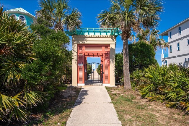 47 Hidden Treasure Dr, Palm Coast, FL 32137 - view of exterior entry with a gate and stucco siding