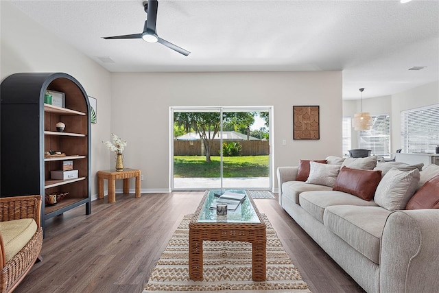 8 Zelda Ct, Palm Coast, FL 32164 - living room featuring healthy amount of natural light, dark wood-style floors, a ceiling fan, and baseboards