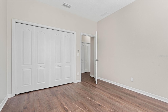 8 Zelda Ct, Palm Coast, FL 32164 - unfurnished bedroom featuring wood finished floors, baseboards, and a closet
