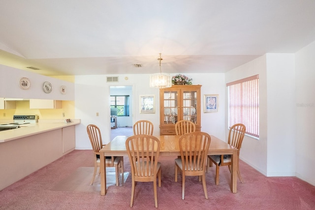 13 Point Of Woods Dr, Palm Coast, FL 32164 - dining space with light carpet, a chandelier, and baseboards