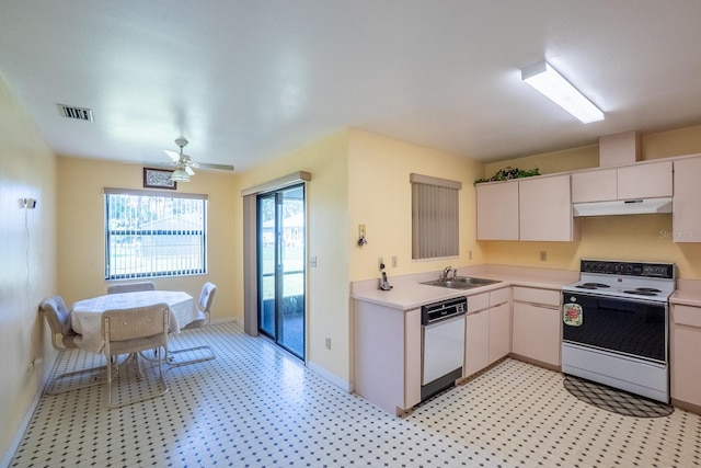 13 Point Of Woods Dr, Palm Coast, FL 32164 - kitchen with white appliances, under cabinet range hood, a sink, and light countertops